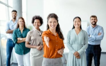 Head shot portrait smiling businesswoman offering handshake, standing with extended hand in modern office, friendly hr manager or team leader greeting or welcoming new worker